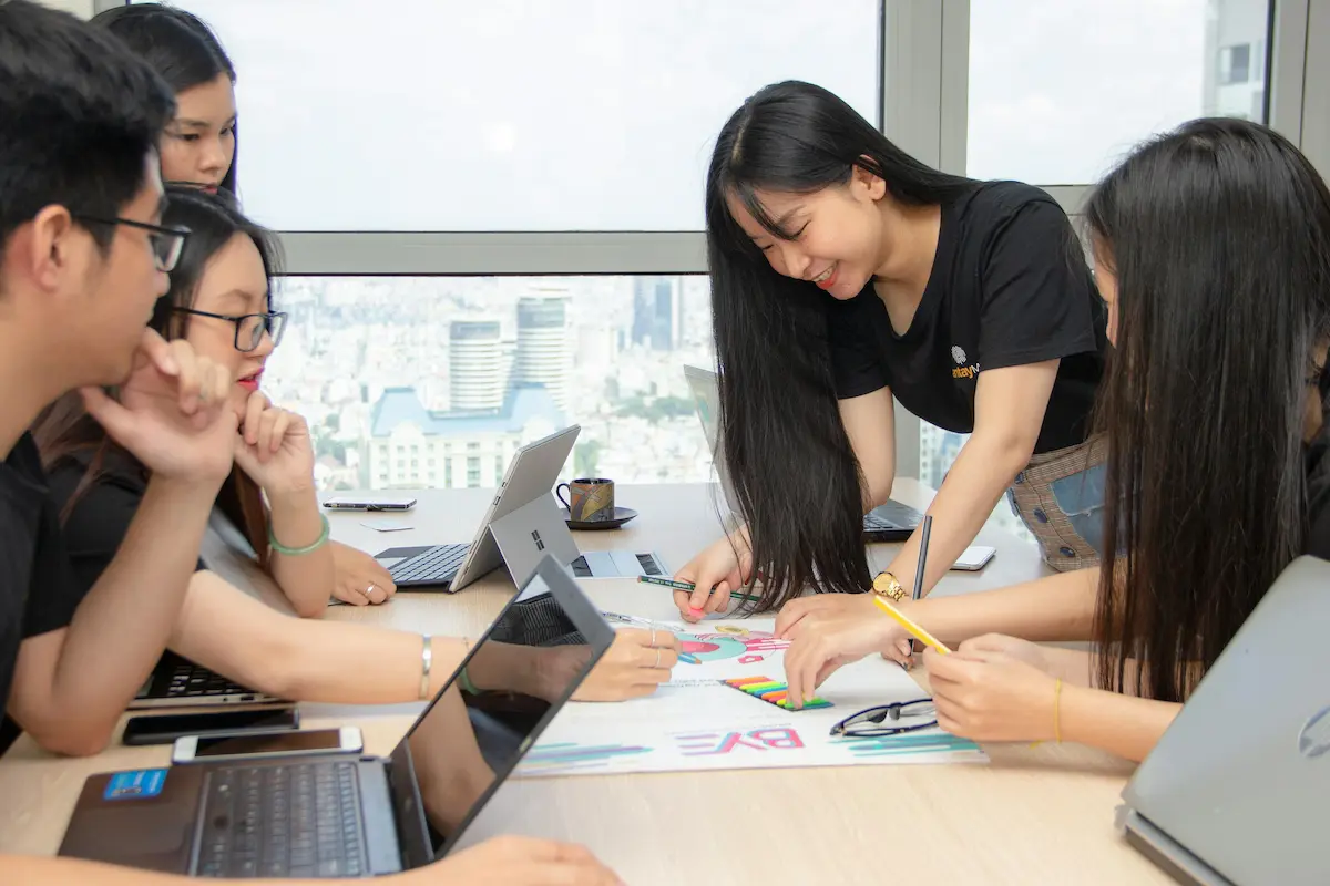 relaxed young people in workplace setting working together